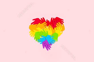 Pride, LGBT flag symbol concept with rainbow color palm hands heart butterfly shape on pink background with copy space