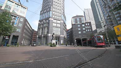 Red and dark brown tram in The Hague city center