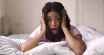 Surprised african american girl touching her head in amazement