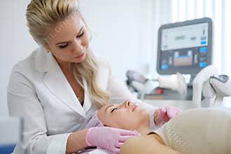 Woman getting treatment with aesthetic dermatology device