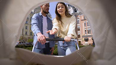 Nervous husband and wife arguing looking at baby in pram, misunderstanding, pov