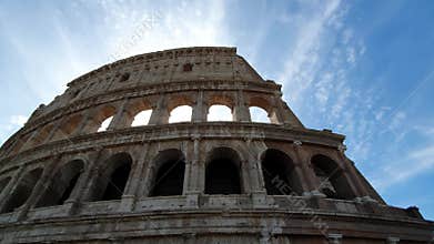 A ray of sun passes through the arches of the Colosseum in Rome, Italy.