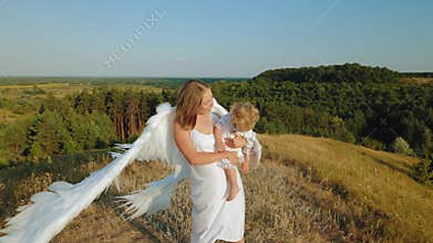 A girl with a child in her arms is dressed like angels