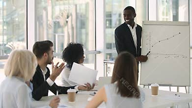 African business trainer asks questions checks knowledge of training participants