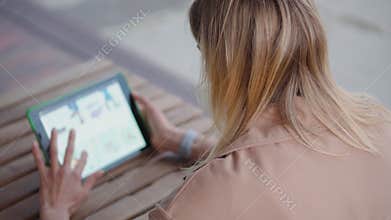 Woman with a gadget outdoor.
