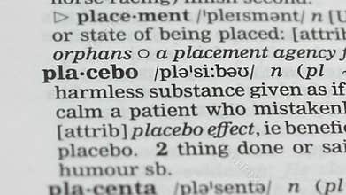 Placebo, pencil pointing word in dictionary, harmless pills, scientific studies