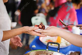 Volunteers giving food to poor people in desperate need : The concept of food sharing Help solve Hunger for the homeless