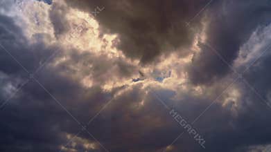 Epic sky where the sun`s rays break through the dramatic clouds