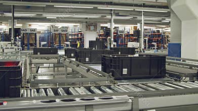 Boxes on a conveyor belt in a large automated warehouse