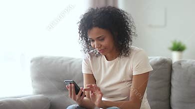Happy african woman swiping in phone dating app feel excited