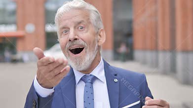 Outdoor Portrait of Shocked Old Businessman Wondering in Awe