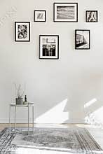 Empty living room interior with coffee table, rug and posters on the floor