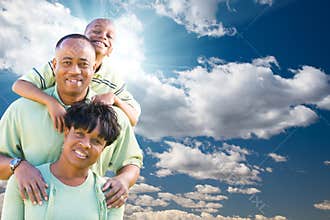 African American Family Over Blue Sky and Clouds