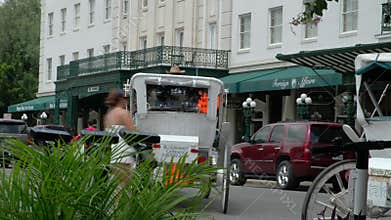 Street scene with coachman riding a horse-drawn carriage in San Antonio, Texas