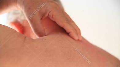 Man tries to rub his sore back