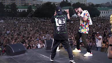 Spain - Barcelona, 07.09.2019: rear view of two rappers shaking hands on the stage during the concert. Action. Two hip