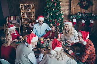 Merry christmas large family reunion gathering meeting sit table have x-mas feast father in santa claus hat cap joke