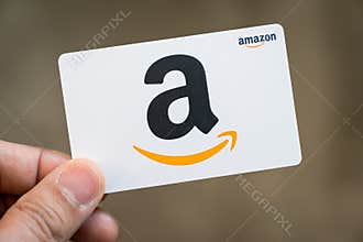Hand hold an Amazon gift card isolated
