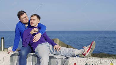 Two gay sit at sea