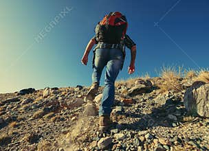 Hiker or backpacker goes uphill