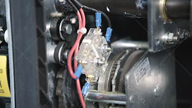 Gear motor recharges the spring in vacuum Automatic circuit breaker, fuses in a big industrial electric rack