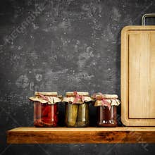 Wooden tray and jars on wooden shelf. Copy space for your decoration and products. Dark gray retro wall background.