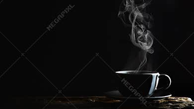Beverage background of hot coffee, tea or chocolate in black cup on wooden plank in dark background
