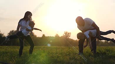 Happy family playing with children on the street. Dad and mom have fun spending the weekend with their son and daughter.