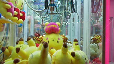 Colorful arcade game toy claw crane machine where people can win toys and other prizes