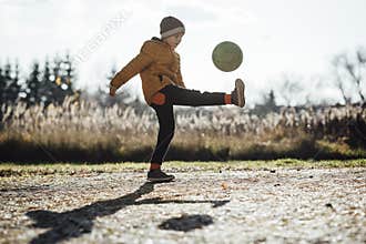 Young boy playing football