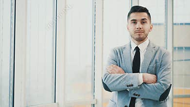 Business man is serious, looking at the camera, isolated on white blurred background. Copy space. 4K.