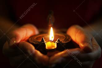 Oil lamp in hands