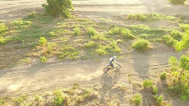 Man riding enduro motorcycle on dirt track
