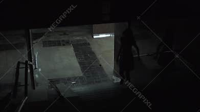 A lonely girl leaves the underpass at night. Dangerous and dirty night quarter, night city.