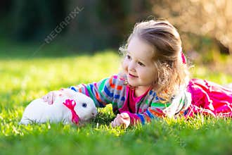 Child with rabbit. Easter bunny. Kids and pets
