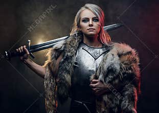 Portrait of a beautiful warrior woman holding a sword wearing steel cuirass and fur. Fantasy fashion. Cosplayer as Ciri