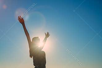 Silhouette of girl with arms wide apart