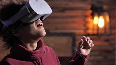 Amazed boy looking around in virtual reality