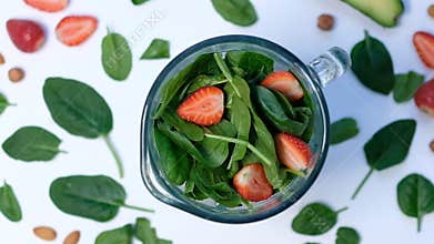 Healthy green smoothie blended with a blender. spinach and avocado on a white background top view. Close up of cooking