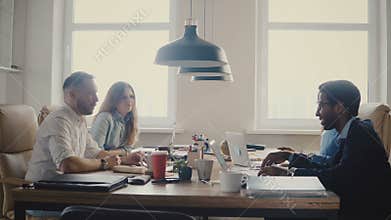 Happy multiethnic business partners smile and discuss international collaboration at modern trendy office meeting 4K.