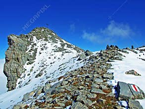 Alpine peak Falknis in the Ratikon border mountain massif or Raetikon Grenzmassiv and over the river Rhine valley Rheintal