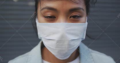Woman wearing medical coronavirus mask on the street