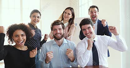 Happy diverse employees group celebrate corporate success look at camera