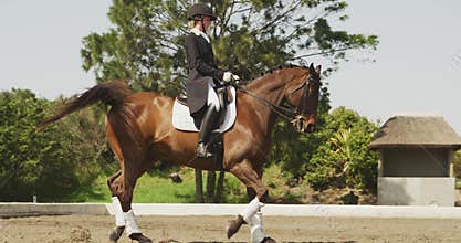 Caucasian woman riding her dressage horse