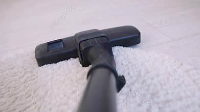 POV of a vacuum cleaner moves on the floor of a bedroom path closeup