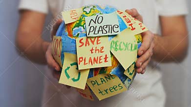 Man hands hold Earth globe with stickers