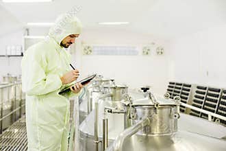 Food beverage worker working check fermentation tank with clean hygiene condition workplace