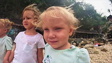 The sister's triplets stand in the wind and look ahead