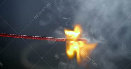 Following the lit fuse burning, sparking, and smoking