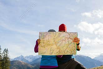 Couple hiking with map in mountains